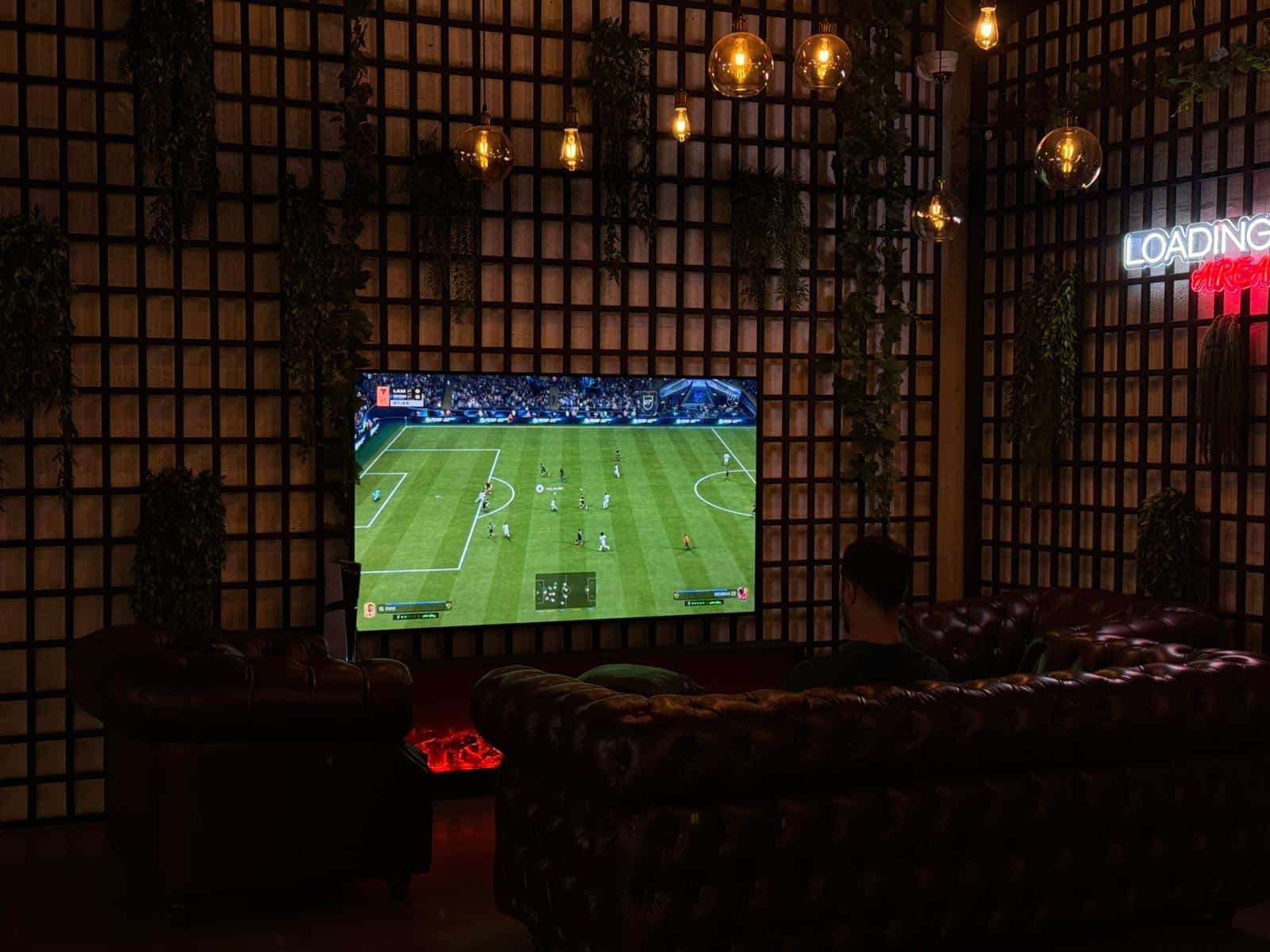 The VR Point lounge with leather sofas and a PS5 area