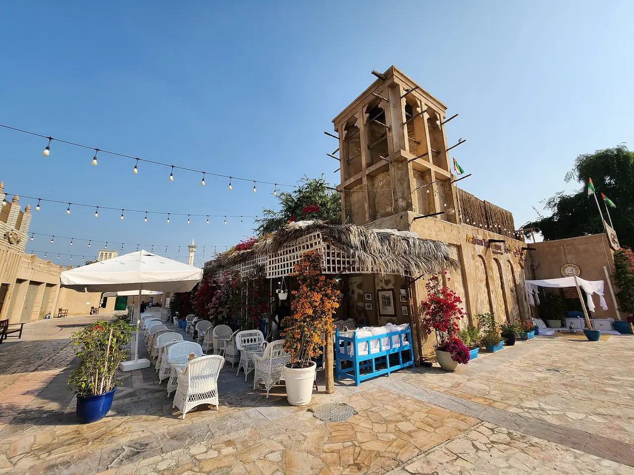 The Best Day in Dubai: A One-Day Itinerary With Every Dirham Counted 6 Arabian Tea House in Al Fahidi, Dubai: wind tower, white rattan chairs and string lights in the courtyard